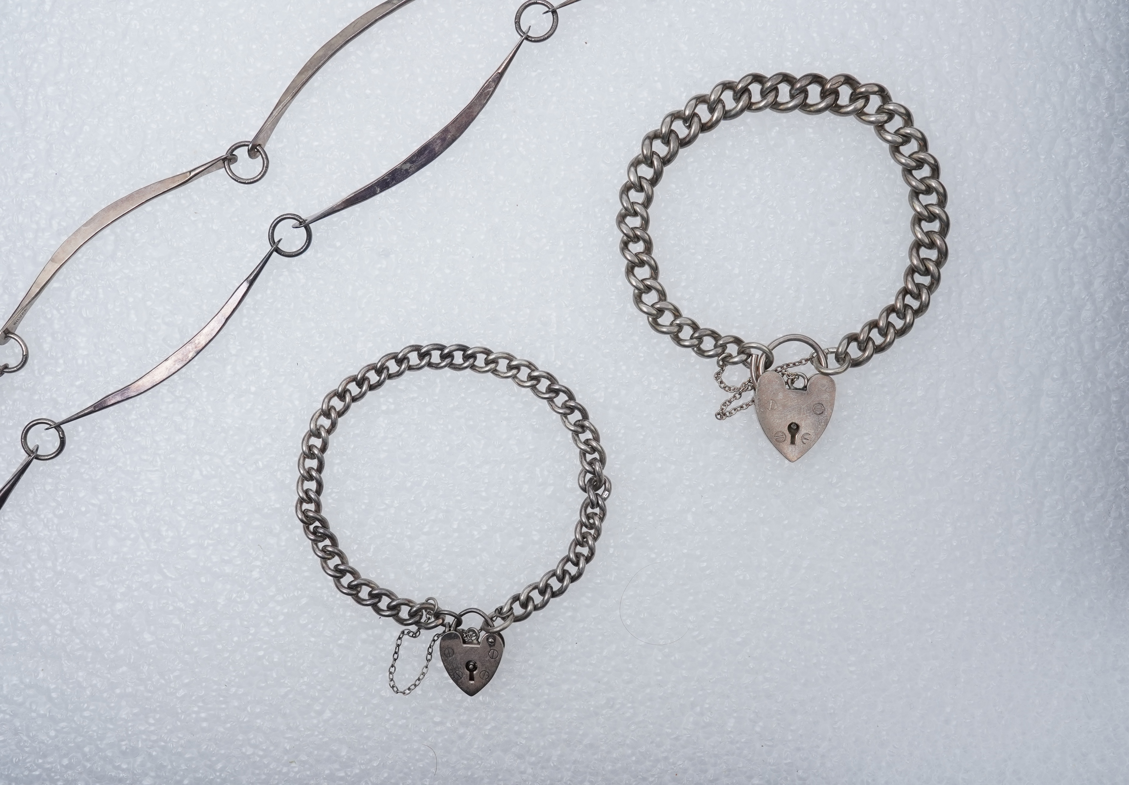A 1960'sGeorg Jensen silver tie clip, design no. 63, 53mm, together with a stylish sterling necklace and two silver curb link bracelets.